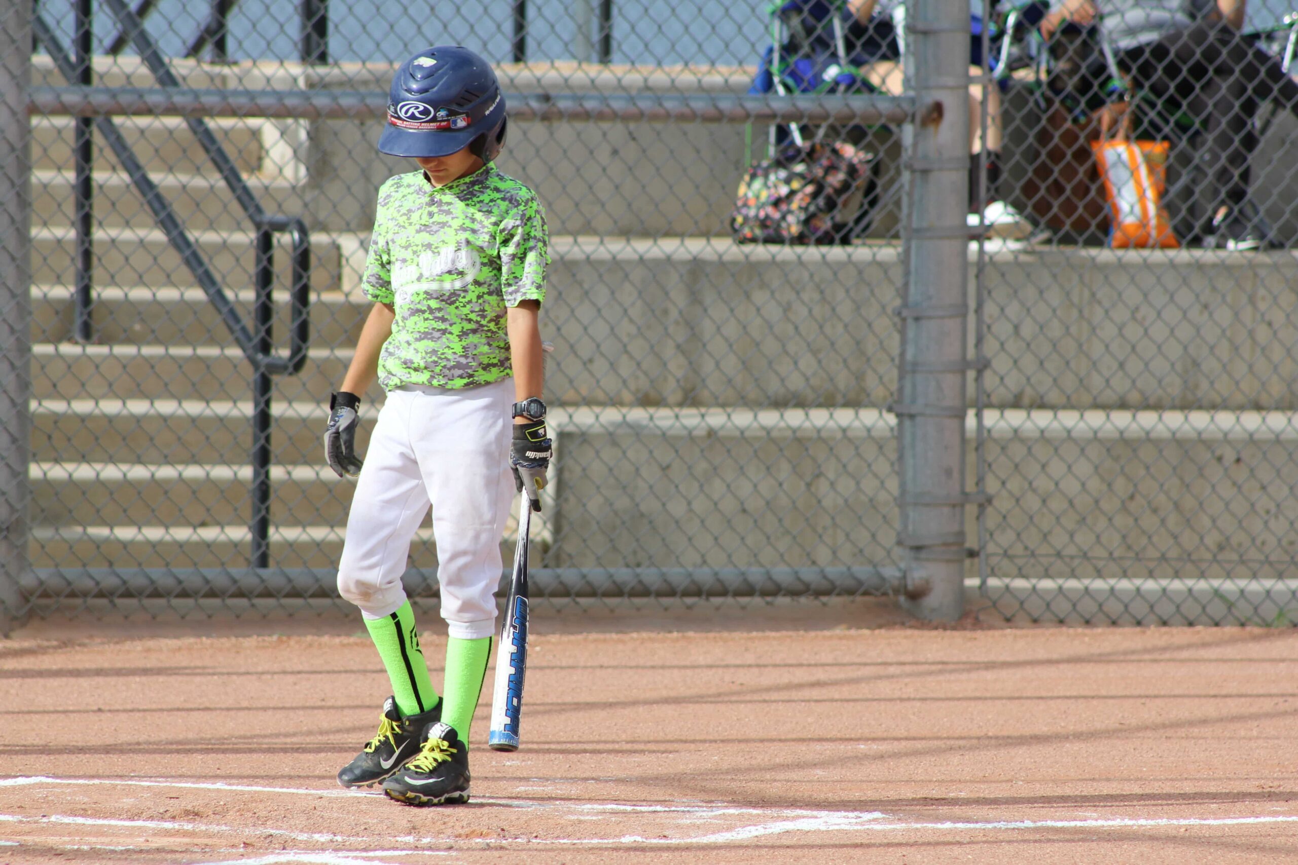 Child with baseball bat on field