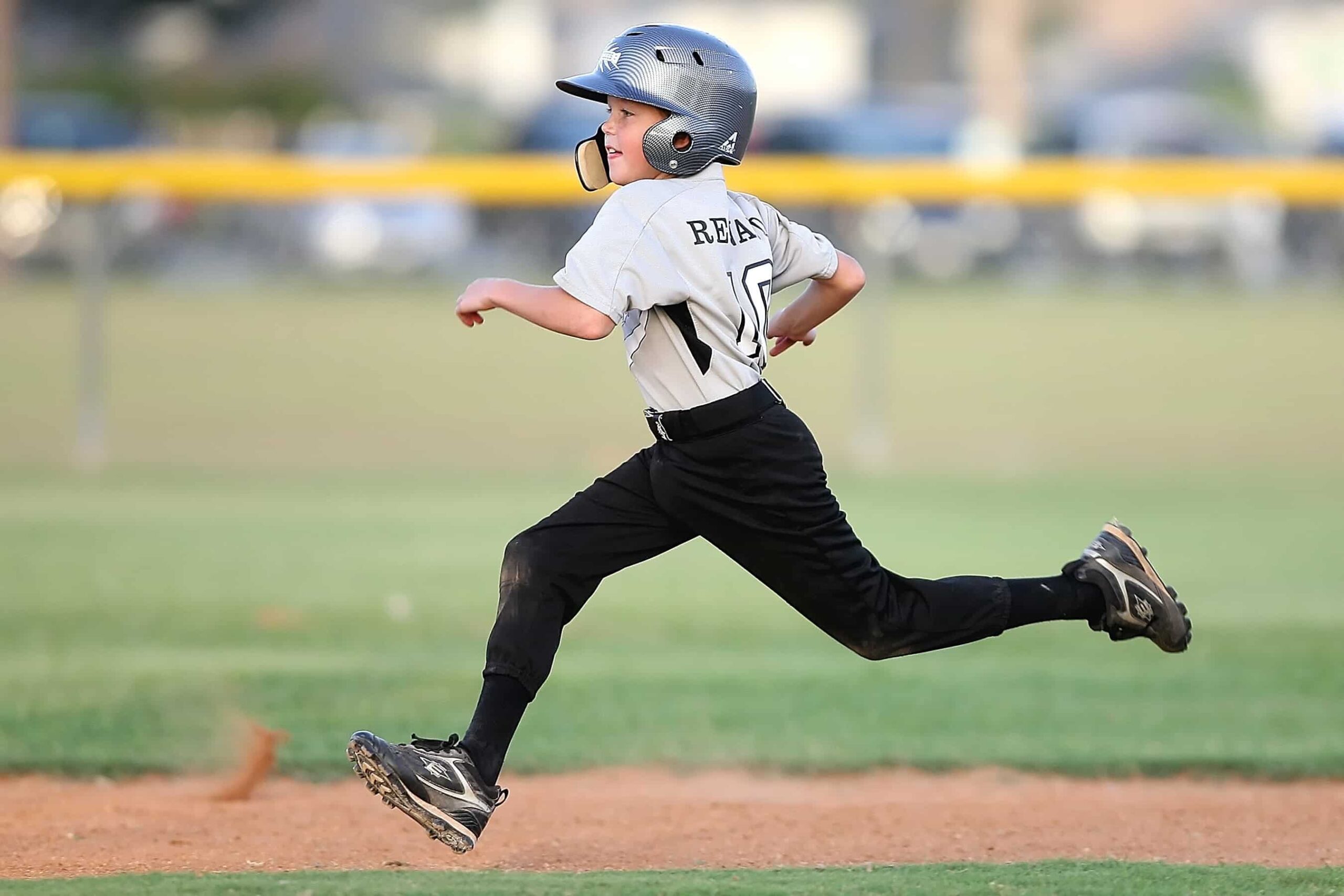 Child running on baseball field