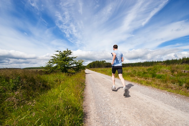 Man running outside on a trail