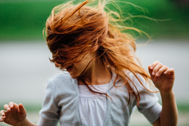 Girl having fun shaking head dance