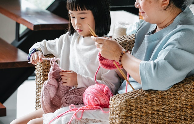 Kid and adult knitting