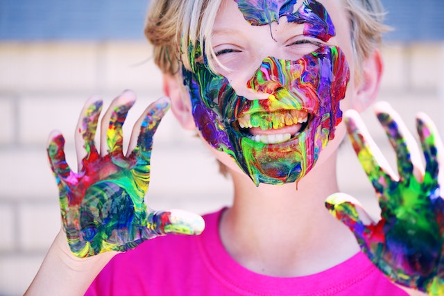 Little girl painted face colorful, fun