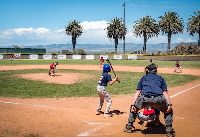 Kid and pitcher outside baseball