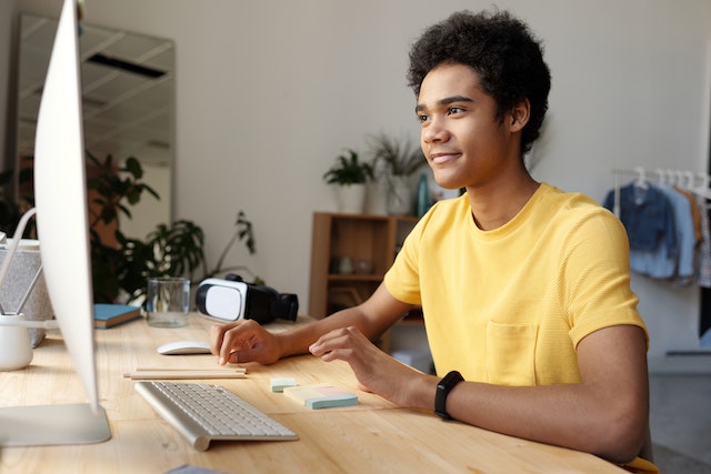 Guy in front of laptop smiling