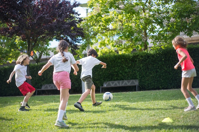 Kids running playing soccer