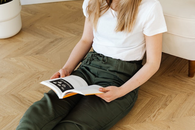 Teen reading on floor