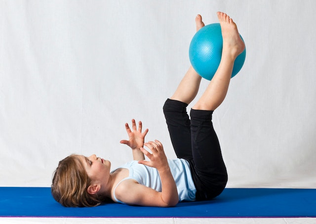 Little girl on floor with ball