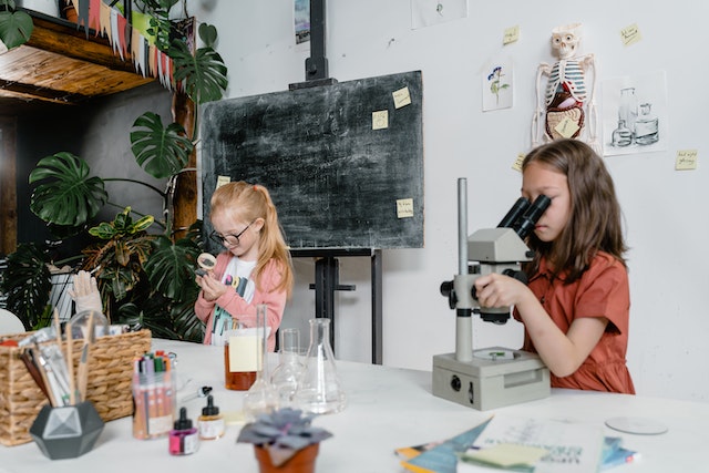 2 girls with science equipment