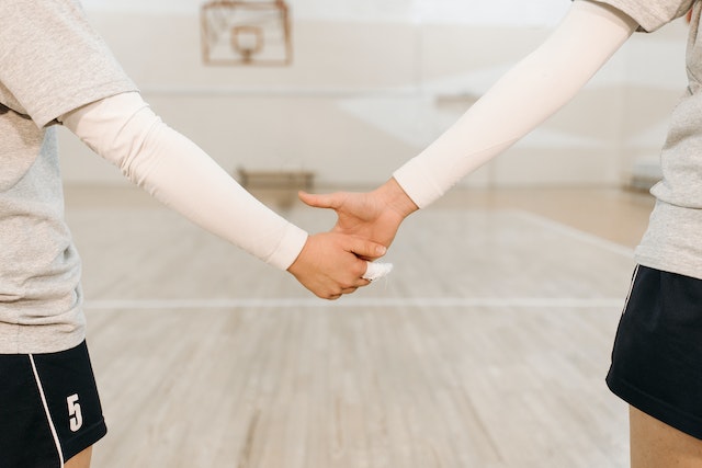 Girls holding hands volleyball