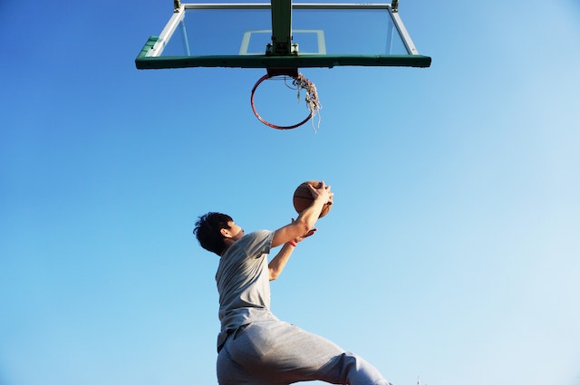 Boy jumping up to make a basketball