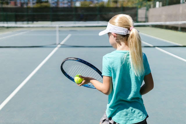 Blonde girl playing tennis