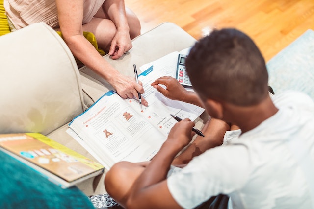 Child getting tutoring help open book