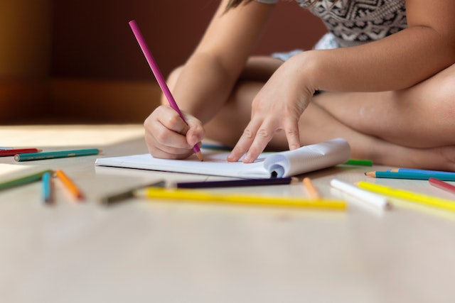 Child doing work on floor