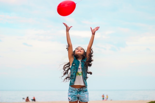 Girl throwing a balloon in the air