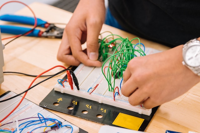 Child doing STEM robotics, circuit board